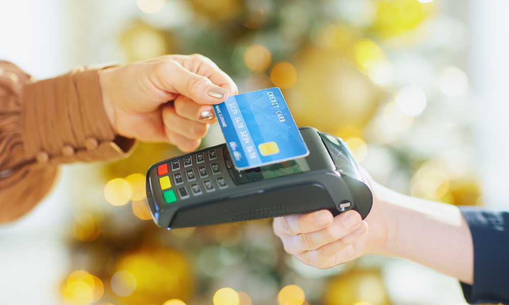 Customer making a contactless card payment on a POS terminal, representing secure digital payments and retail transactions
